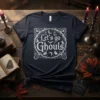 Let's go Ghouls text design with ghosts and bats on a dark t-shirt, perfect for Halloween