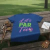 Blue t-shirt with "Let's PAR Tee" text and a golf ball on a tee graphic