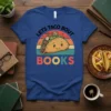 Lets Taco Bout Books t-shirt with a smiling taco graphic and retro sunset