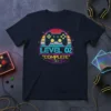 Level 02 Complete Complete anniversary t-shirt with retro video game controller and circular design elements