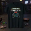 Level 04 COMPLETE text with pixelated hearts and a video game controller graphic on a black t-shirt