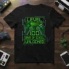 T-shirt with "LEVEL 100 DAYS OF SCHOOL UNLOCKED" text and a video game controller graphic in neon green