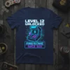 Level 12 Unlocked Awesome Since 2011 birthday t-shirt featuring a retro arcade game design and neon blue text