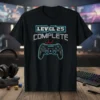 Black t-shirt with "LEVEL 25 COMPLETE" text and a video game controller graphic