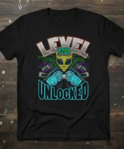 Level 28 Unlocked t-shirt featuring an alien gamer holding a controller, with circuit board graphics and digital text