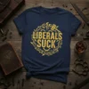 Navy blue t-shirt with yellow "LIBERALS SUCK" text inside a thorny crown design with a broken gavel and gears