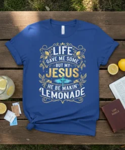 T-shirt with the quote "Life Gave Me Some But My Jesus He Be Makin' Lemonade" in gold and blue text