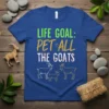 Life Goal: Pet All The Goats t-shirt design featuring green and gold text with illustrations of goats