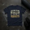 Navy t-shirt with "Life Has Its Ups And Downs I Call Them Squats" text and barbell graphics, designed for gym
