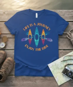 Blue t-shirt with orange text "LIFE IS A JOURNEY ENJOY THE RIDE" and three colorful kayaks with paddles graphic