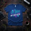 Blue t-shirt with "LIFE SUCKS BUT BUT I SUCK BETTER" in neon pink and turquoise geometric design