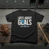 T-shirt with "Life's About Goals (And Assists)" text and graphic of a hockey player scoring a goal