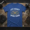 Lift Heavy Pray Hard t-shirt with barbell, open book, and crosses graphic