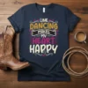 Line Dancing Makes My Heart Happy quote in colorful, playful typography on a navy t-shirt, featuring cowboy boot graphics and
