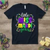 Little Miss Mardi Gras text design with festive beads and mask on a navy t-shirt, perfect for carnival celebrations