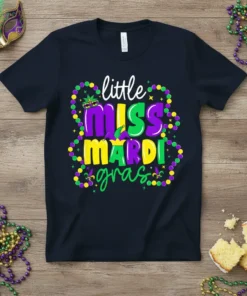 Little Miss Mardi Gras text design with festive beads and mask on a navy t-shirt, perfect for carnival celebrations