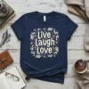 Live Laugh Love quote t-shirt with floral wreath design in pastel colors