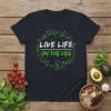 Black t-shirt with "LIVE LIFE ON THE VEG" text surrounded by green vegetables and broccoli graphics