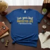 Blue t-shirt with gold and white text: "Live your best PROTECTED LIFE #AskTheInsuranceLady"