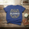 Living my Blessed Life quote on a blue t-shirt, surrounded by gold floral and bird design elements