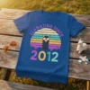 Llamazing Since 2012 retro t-shirt with a black llama wearing sunglasses and a colorful sunset graphic