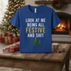 Blue t-shirt with white and gold text "LOOK AT ME BEING ALL FESTIVE AND SHIT" and two Christmas trees