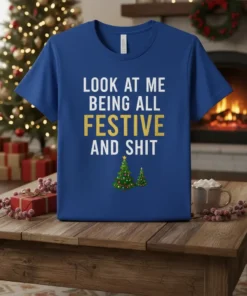 Blue t-shirt with white and gold text "LOOK AT ME BEING ALL FESTIVE AND SHIT" and two Christmas trees
