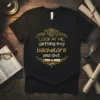 Black t-shirt with gold text "LOOK AT ME, getting my bachelors and shit." and graduation cap and scroll graphics