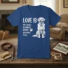 Blue t-shirt with "Love Is Wet Noses Slobbery Kisses Wagging Tails" text and a drawing of a golden retriever dog