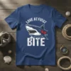 Love At First Bite shark graphic t-shirt with white text and a broken heart detail