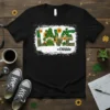 Black t-shirt with "LOVE #CNAlife" design, featuring a gnome, sunflowers, and shamrocks