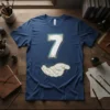 Graphic t-shirt featuring the number 7 in white with blue and gold accents, with a hand graphic below