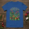 Lush Green Escape t-shirt design featuring vibrant tropical flowers, ferns, hummingbirds, and butterflies with ornate golden text