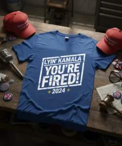 Blue t-shirt with "LYIN' KAMALA YOU'RE FIRED! 2024" in white distressed block letters and yellow stars
