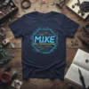M.I.K.E Man, I Know Everything! quote on a navy t-shirt with a blue and yellow circuit board design