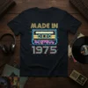 Retro "Made In Best Of February 1975" design on a navy t-shirt featuring a neon cassette tape graphic