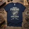 Make Fishing Great Again text with bass fish graphic and fishing rods on a navy t-shirt
