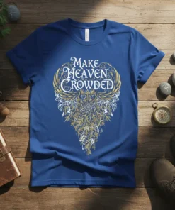 Make Heaven Crowded quote in ornate white and gold lettering on a royal blue t-shirt with intricate wing-like graphics