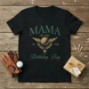 Black t-shirt with "Mama of the Birthday Boy" text and golf graphic, including wings and a trophy
