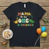 Mama of the One-A-Saurus text with cute dinosaurs graphic on a black t-shirt for a first birthday celebration