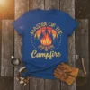 Blue t-shirt with "Master of the Campfire" text and a vintage campfire graphic, perfect for camping lovers