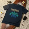 Dark navy t-shirt featuring the word "Maui" in textured gold font and a tribal-style sea turtle with two smaller turtles