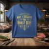 Blue t-shirt with yellow text "May I Suggest The Roast Beef" in decorative font, featuring a meat-themed graphic