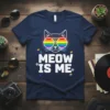 White text "MEOW IS ME" with a cat wearing rainbow sunglasses on a navy t-shirt, featuring small rainbow paw prints