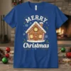 Merry Christmas gingerbread house design with snowflakes and holly on a blue t-shirt