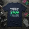 Microbiology Department STAPH t-shirt with green bacteria graphics and magnifying glass, featuring the text "MICROBIOLOGY DEPARTMENT STAPH"