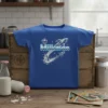 Blue t-shirt with "Milkman" text in a retro font, accompanied by two rockets and stars, symbolizing space delivery