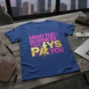 "Mind The Business That Pays You" quote in pink and gold glitter on a blue t-shirt, motivational business design