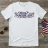 Miss Americana text design with red, white, and blue stars and wavy font on a white t-shirt