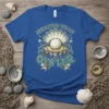 Moister Than An Oyster text with a graphic of a pearl inside an open oyster shell on a blue t-shirt